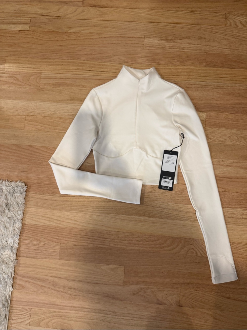 Alo Airlift Winter Warm Ski Time Long-Sleeve Cropped Mock Neck Top in Ivory